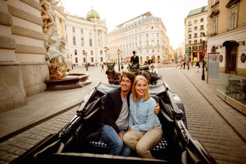 In a traditional horse-drawn carriage on Michaelerplatz